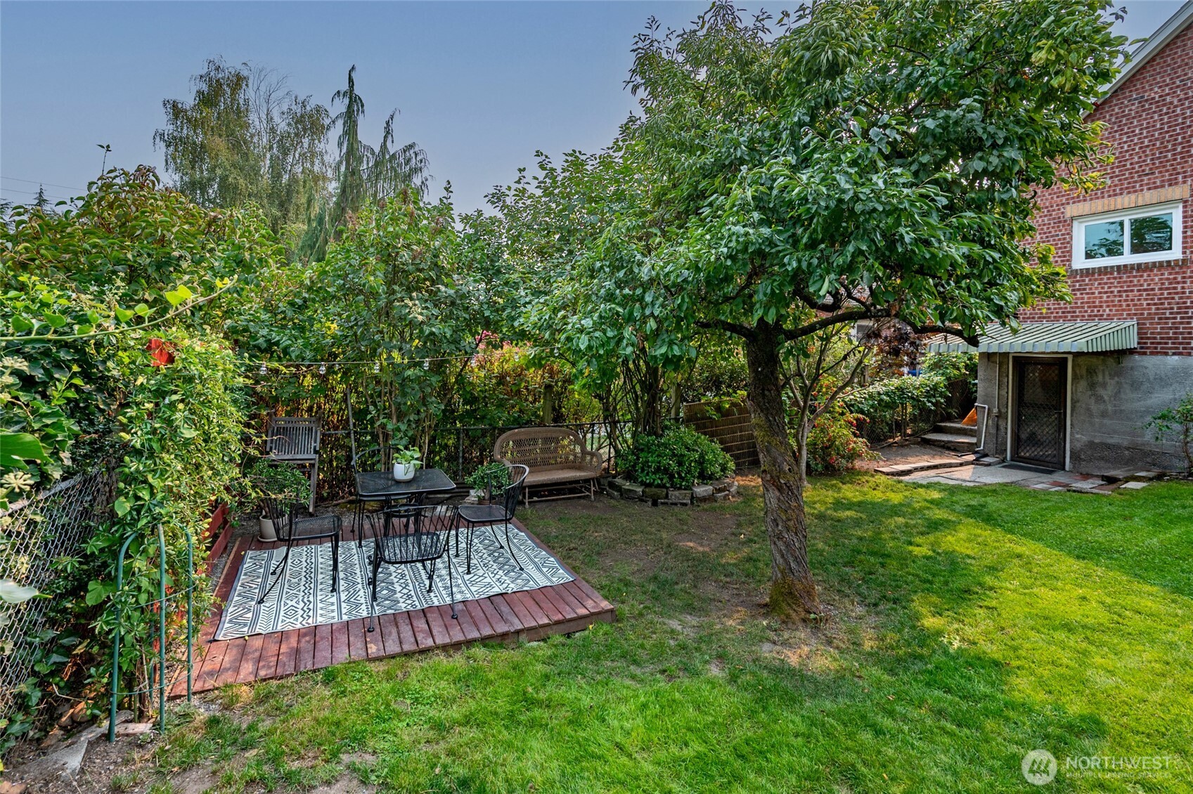334 Northeast 57th Street Seattle, WA 98105 - Photo 36 of 39 a view of a chair and table in backyard of the house