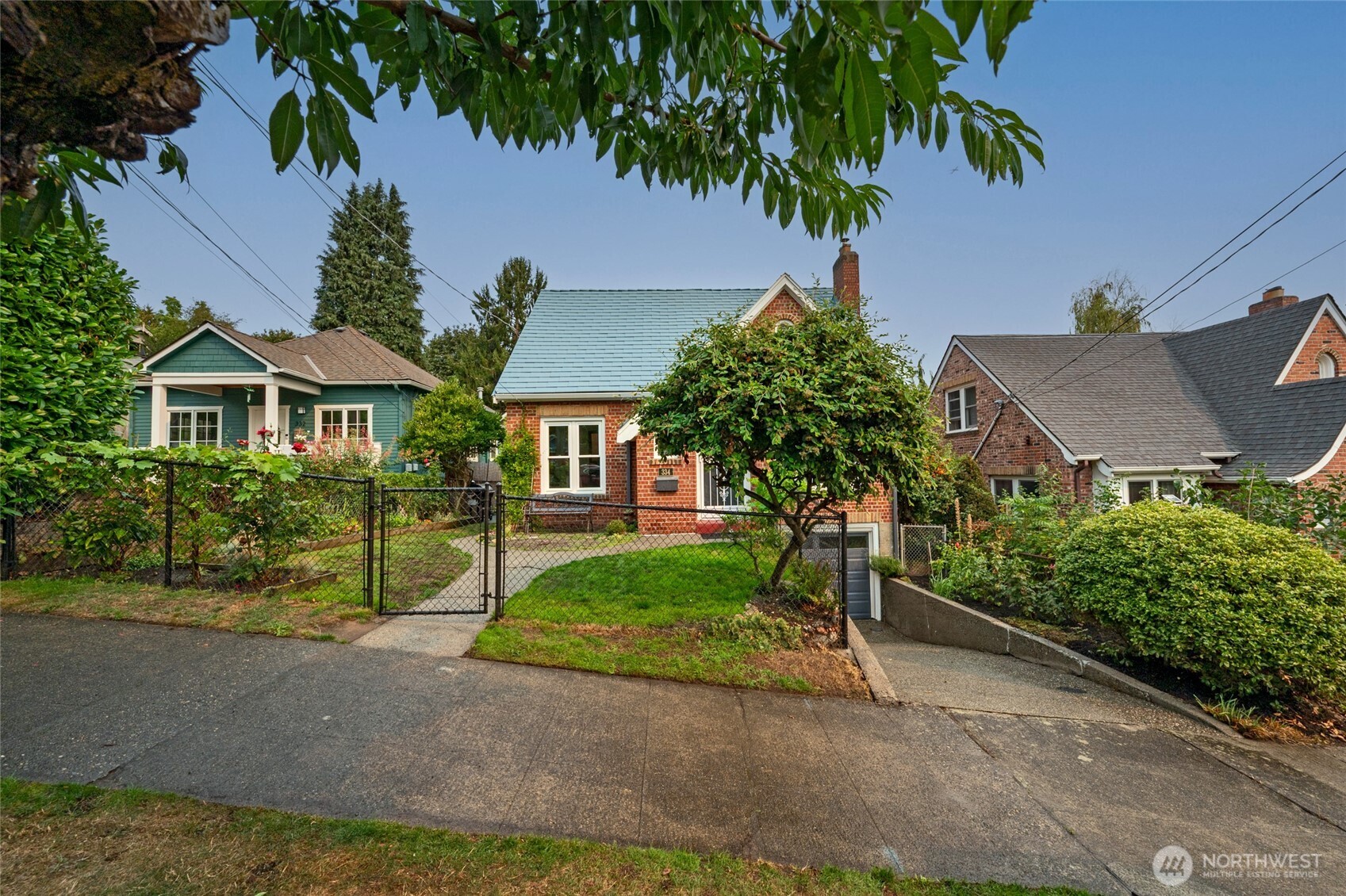 334 Northeast 57th Street Seattle, WA 98105 - Photo 4 of 39 a front view of a house with a yard and garage
