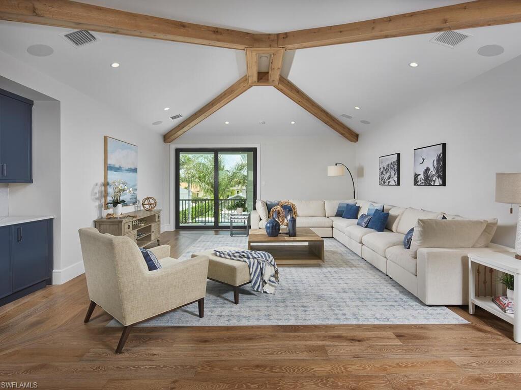 575 17th Avenue South Naples, FL 34102 - Photo 22 of 43 Living room with vaulted ceiling with beams and wood-type flooring