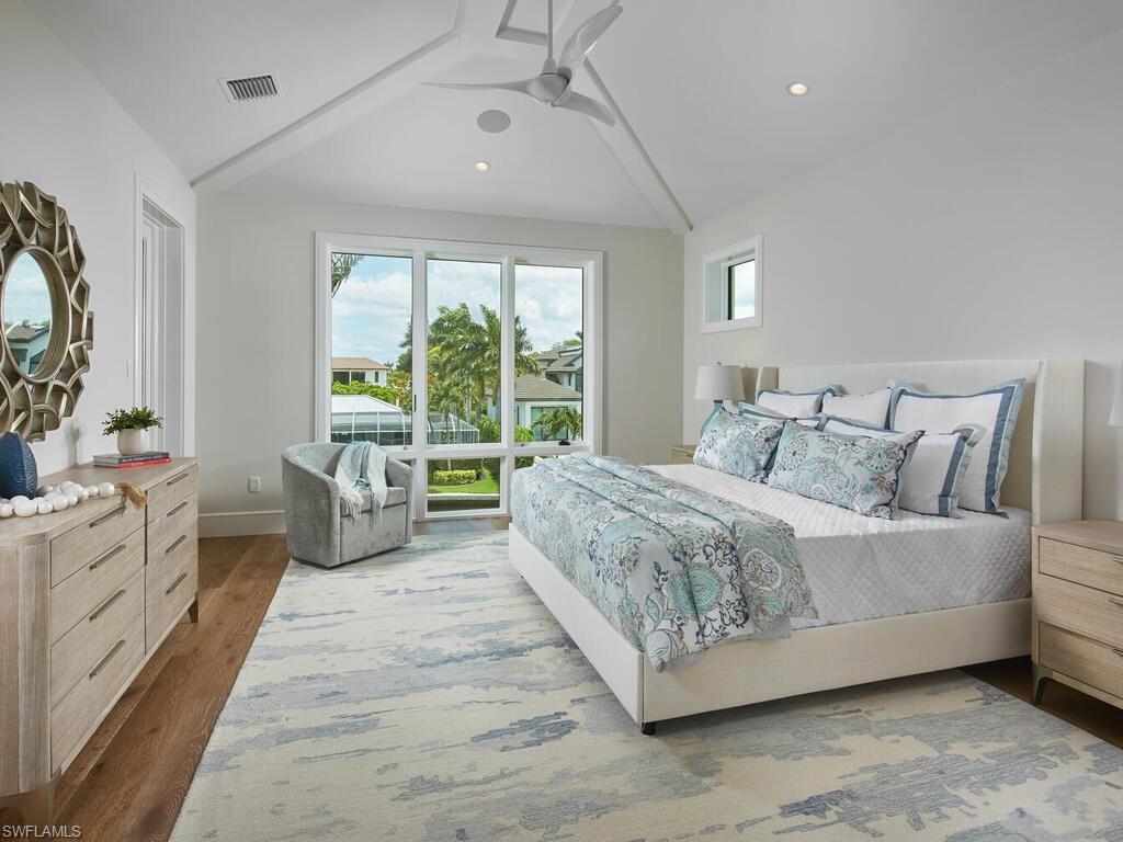 575 17th Avenue South Naples, FL 34102 - Photo 23 of 43 Bedroom featuring ceiling fan, vaulted ceiling, and hardwood / wood-style floors