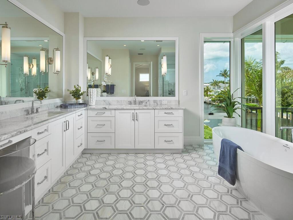 575 17th Avenue South Naples, FL 34102 - Photo 24 of 43 Bathroom with tile flooring, vanity, and a washtub