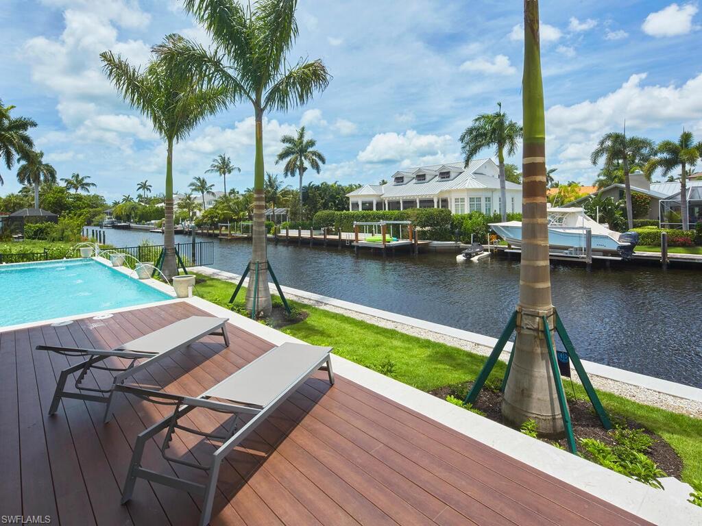 575 17th Avenue South Naples, FL 34102 - Photo 35 of 43 Wooden deck with a boat dock and a water view