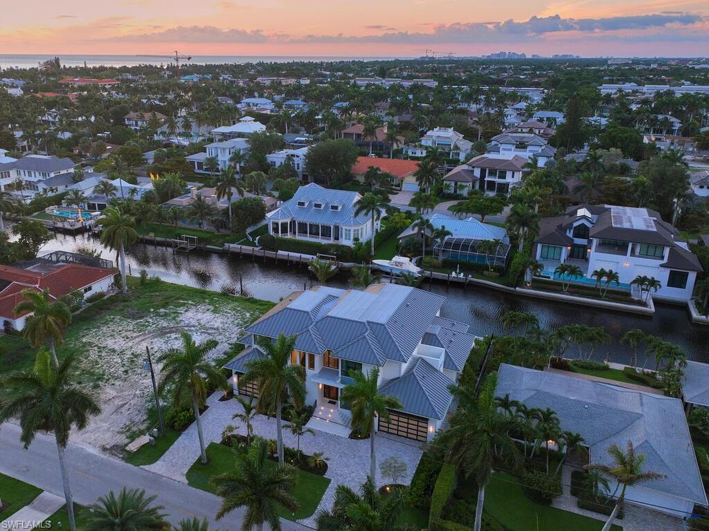 575 17th Avenue South Naples, FL 34102 - Photo 42 of 43 Aerial view at dusk with a water view
