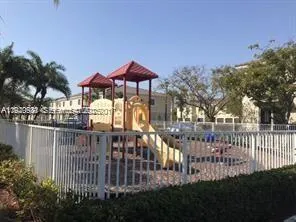 a view of a house with a small yard and a garden