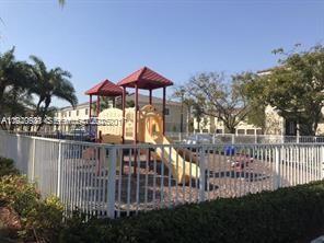 2675 Southwest 81st Terrace, Unit 2641 Miramar, FL 33025 - Photo 14 of 18 a view of a house with a small yard and a garden