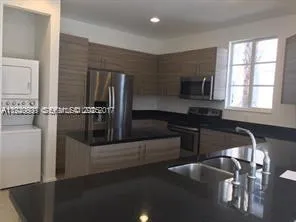 a kitchen with a sink appliances and cabinets