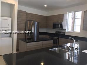 2675 Southwest 81st Terrace, Unit 2641 Miramar, FL 33025 - Photo 2 of 18 a kitchen with a sink appliances and cabinets