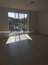 2675 Southwest 81st Terrace, Unit 2641 Miramar, FL 33025 - Photo 7 of 18 a view of an empty room with a floor to ceiling window