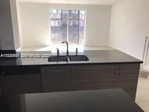 a kitchen with a sink and a window
