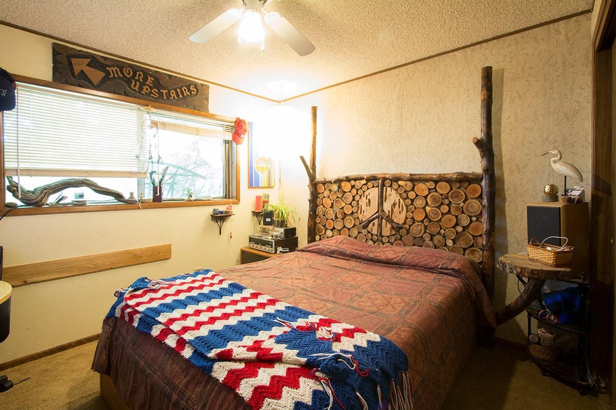 8288 Division Road White City, OR 97503 - Photo 8 of 15 a bedroom with a bed and window