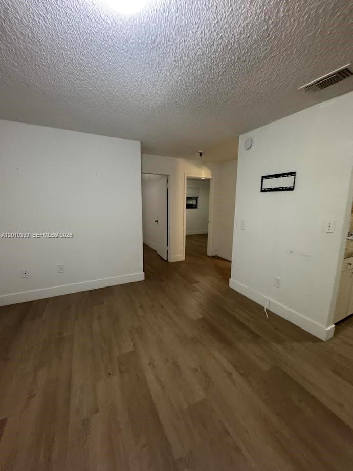120 West 10th Street, Unit 10 Hialeah, FL 33010 - Photo 5 of 6 an empty room with wooden floor and windows