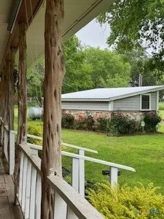a view of a house with a yard from a balcony