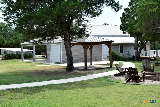 a view of a house with backyard porch and sitting area