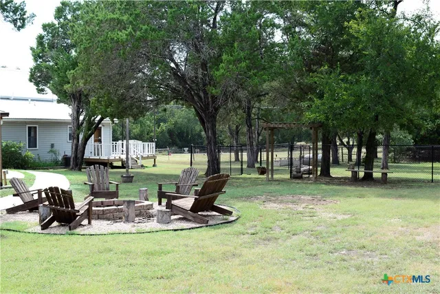 a view of a backyard with sitting area