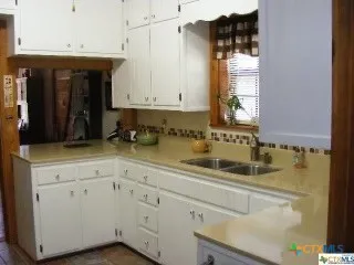 a kitchen with a sink and cabinets