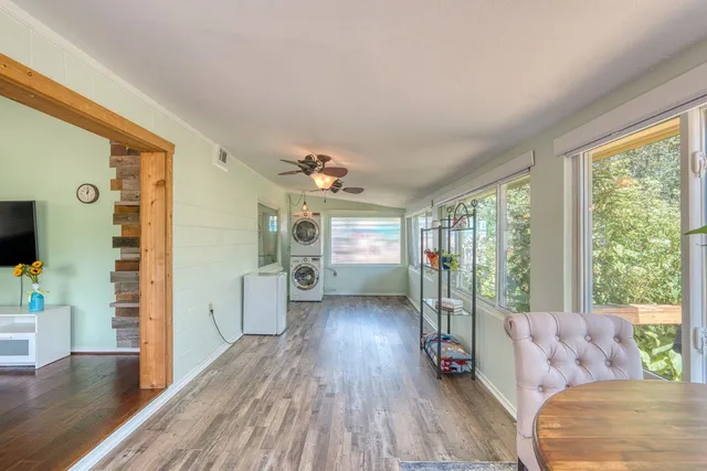 a living room with furniture wooden floor and a large window