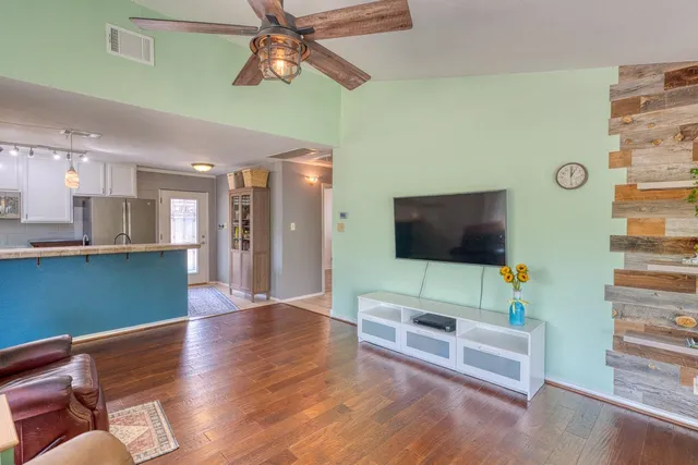 a living room with furniture and a flat screen tv