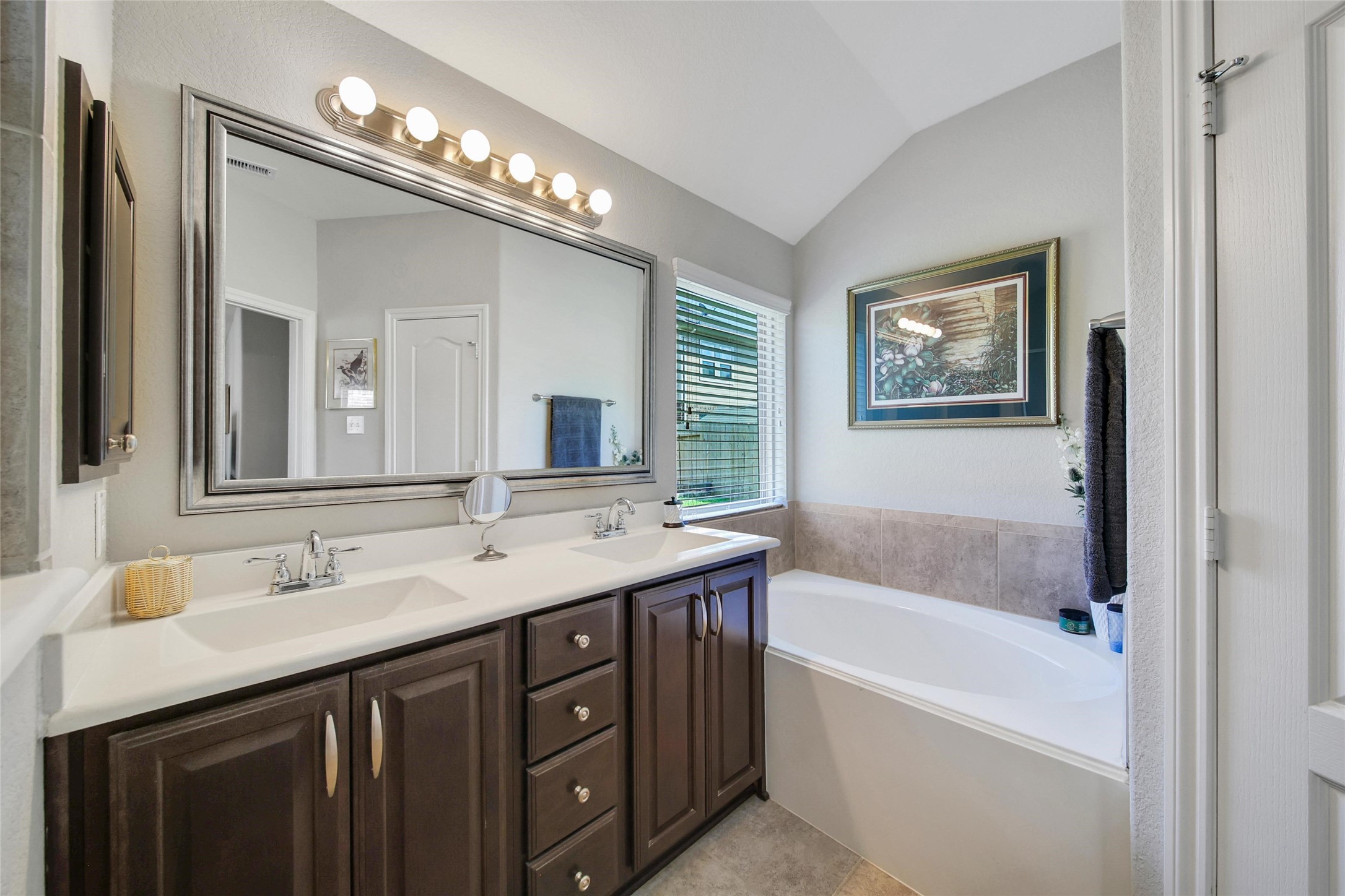214 Pleasant Hill Way Conroe, TX 77304 - Photo 24 of 43 The vanity is perfect for sharing with center storage drawers and a medicine cabinet. A walk-in closet completes the suite.
