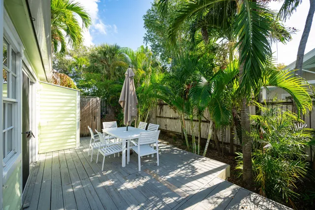 a view of a wooden chairs and table in patio