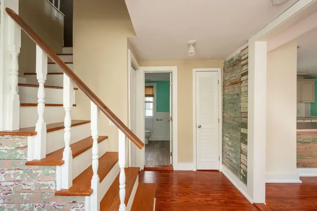 a view of entryway with wooden floor and stairs
