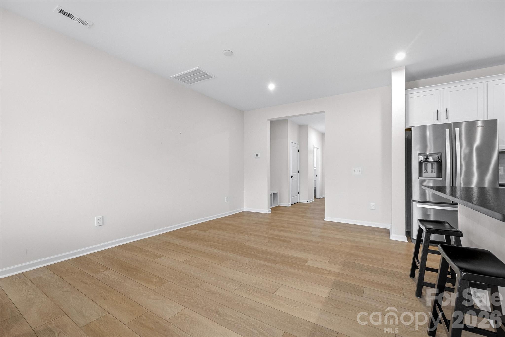 217 Brooks Springs Drive Fort Mill, SC 29708 - Photo 13 of 36 a view of kitchen with refrigerator and wooden floor