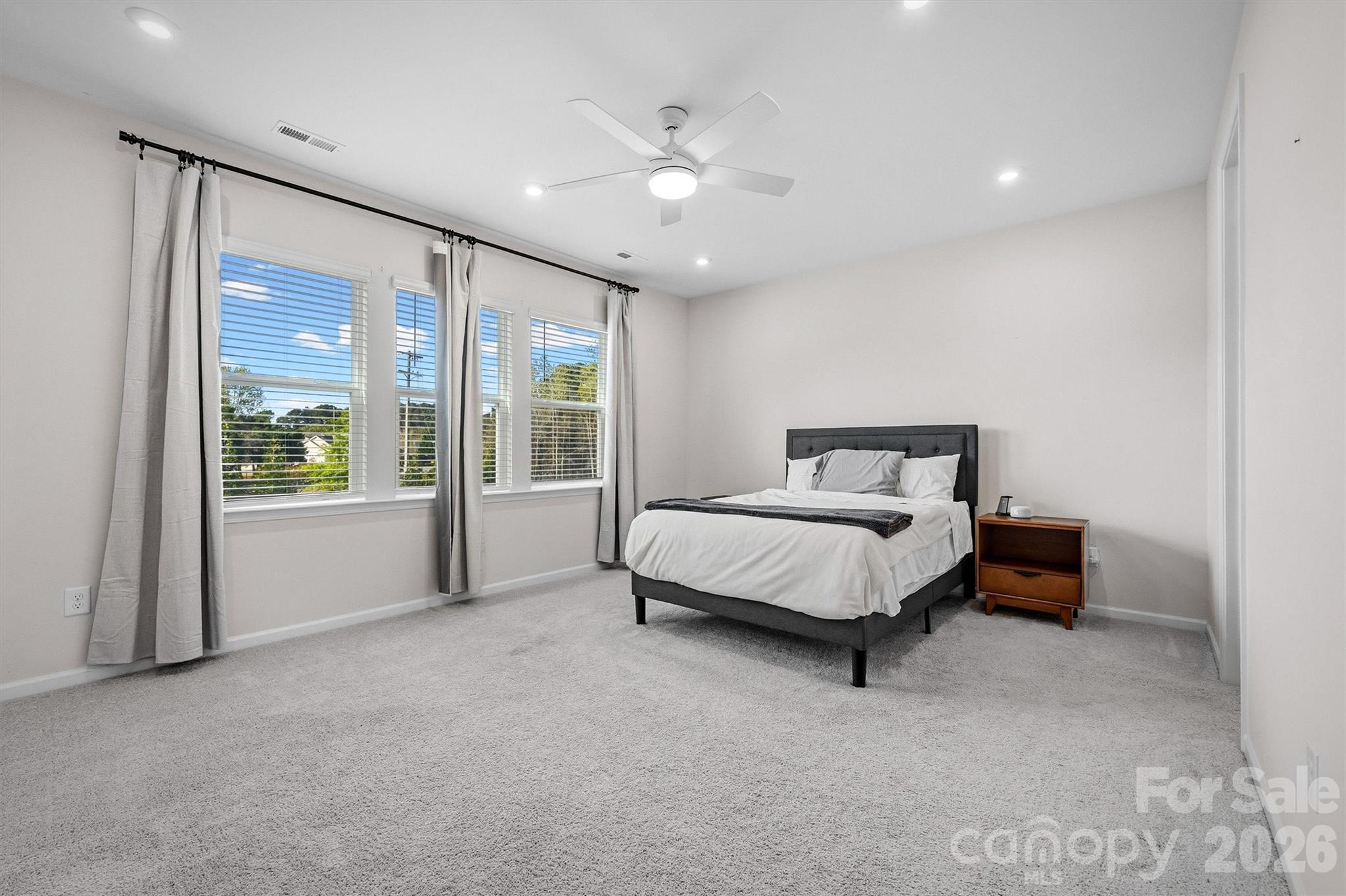 217 Brooks Springs Drive Fort Mill, SC 29708 - Photo 17 of 36 a bed sitting in a room next to a large window