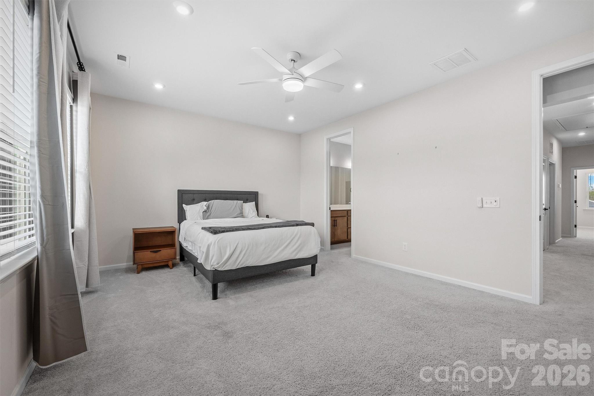 217 Brooks Springs Drive Fort Mill, SC 29708 - Photo 18 of 36 a spacious bedroom with a bed and a ceiling fan