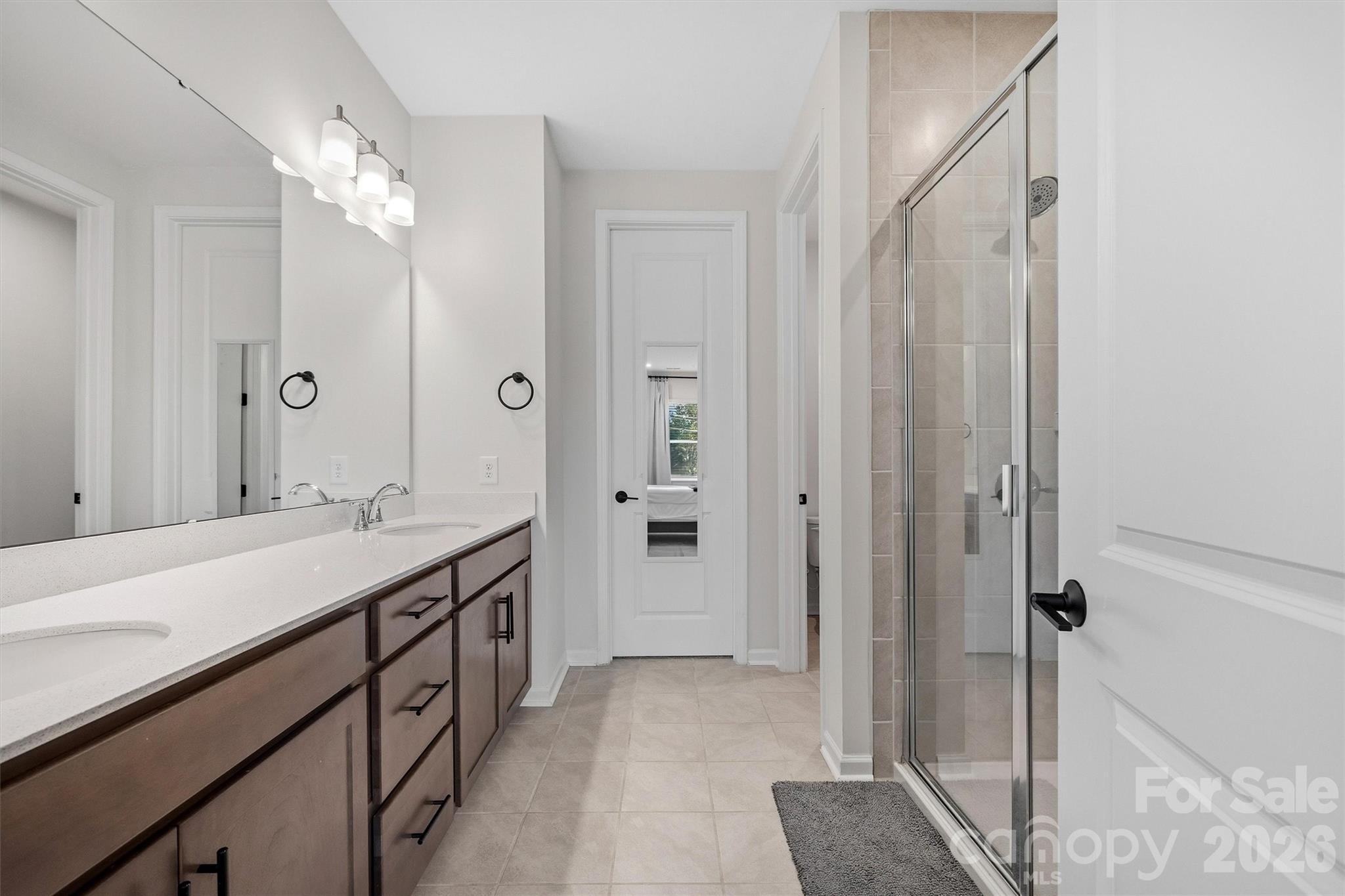 217 Brooks Springs Drive Fort Mill, SC 29708 - Photo 20 of 36 a bathroom with a double vanity sink and mirror