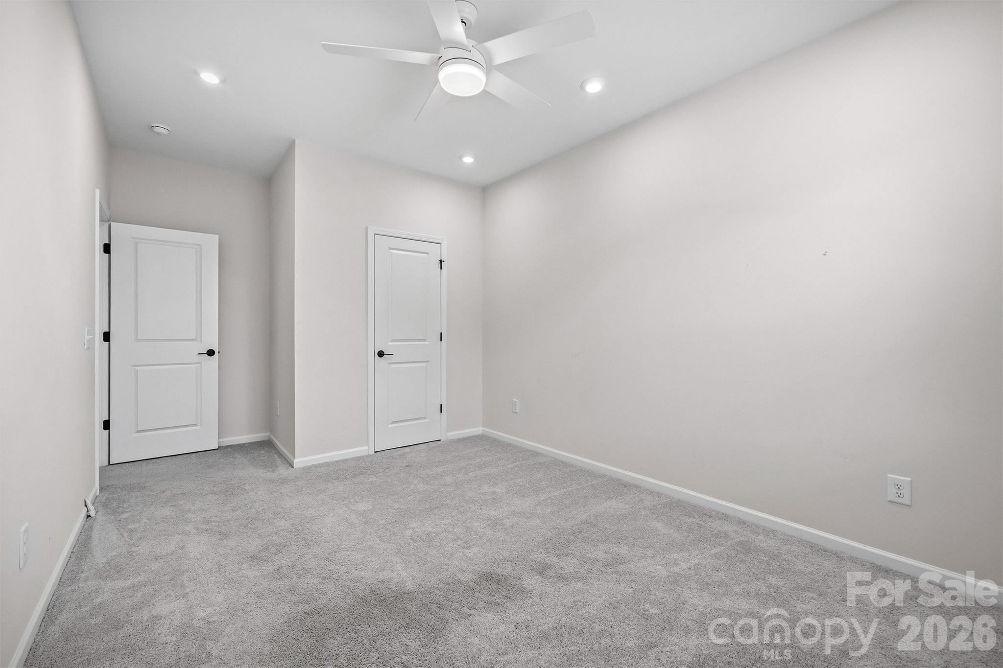 217 Brooks Springs Drive Fort Mill, SC 29708 - Photo 27 of 36 an empty room with a ceiling fan and a window