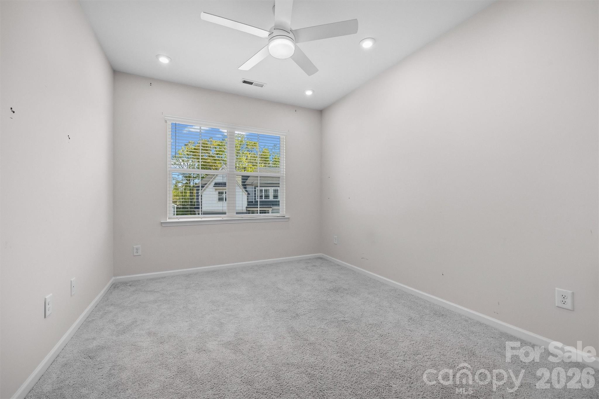217 Brooks Springs Drive Fort Mill, SC 29708 - Photo 28 of 36 en empty room with windows and ceiling fan