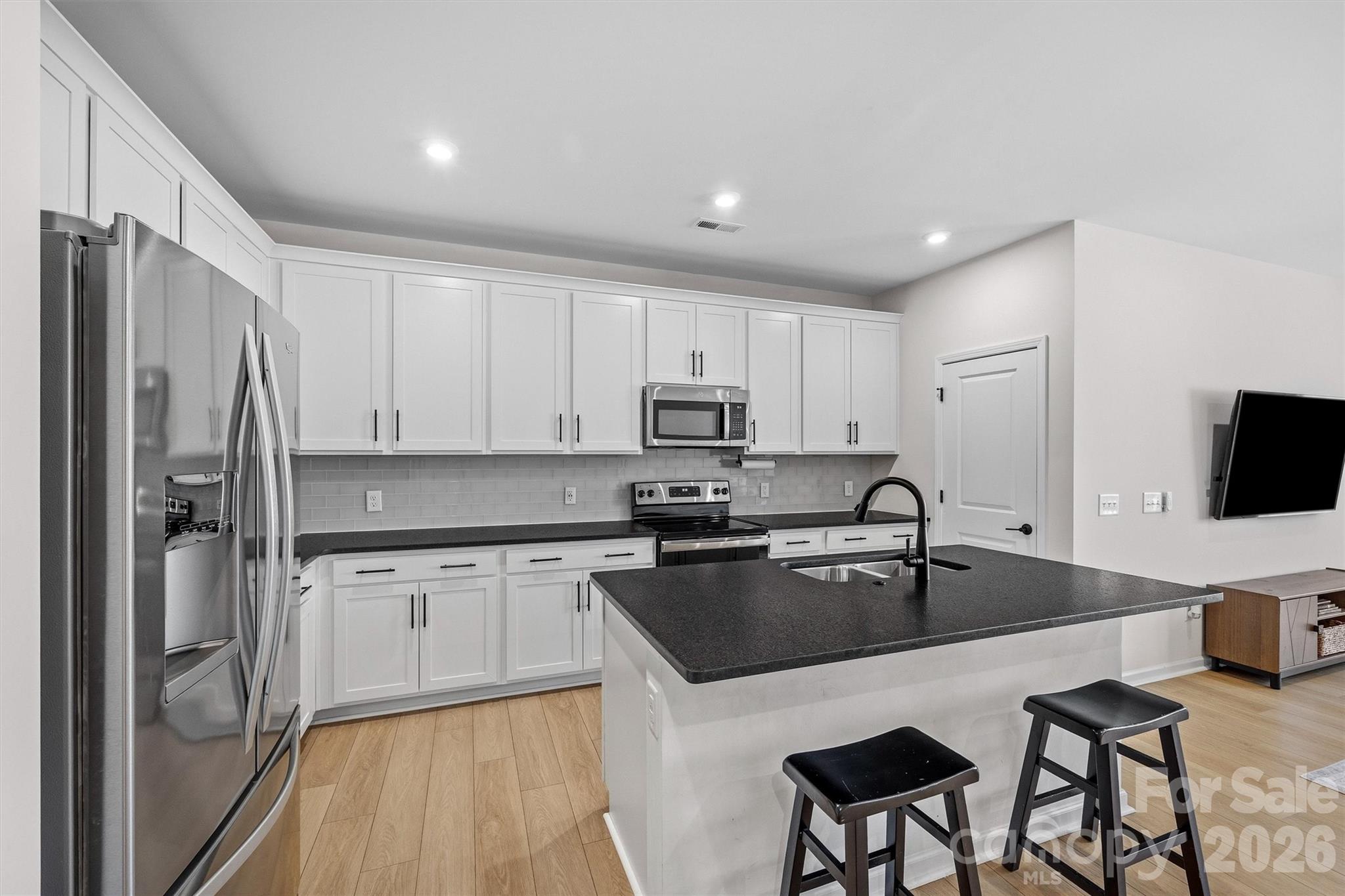 217 Brooks Springs Drive Fort Mill, SC 29708 - Photo 8 of 36 a kitchen with granite countertop a sink stove and refrigerator