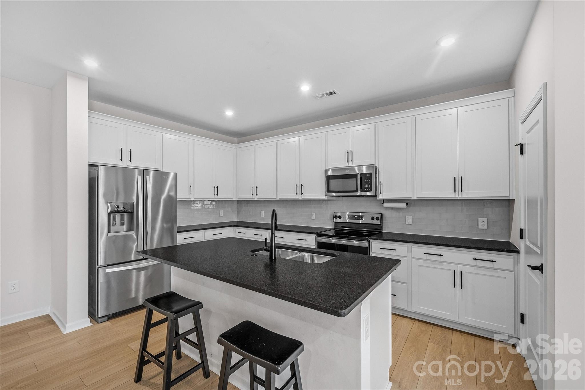 217 Brooks Springs Drive Fort Mill, SC 29708 - Photo 9 of 36 a kitchen with a sink a counter space appliances and cabinets
