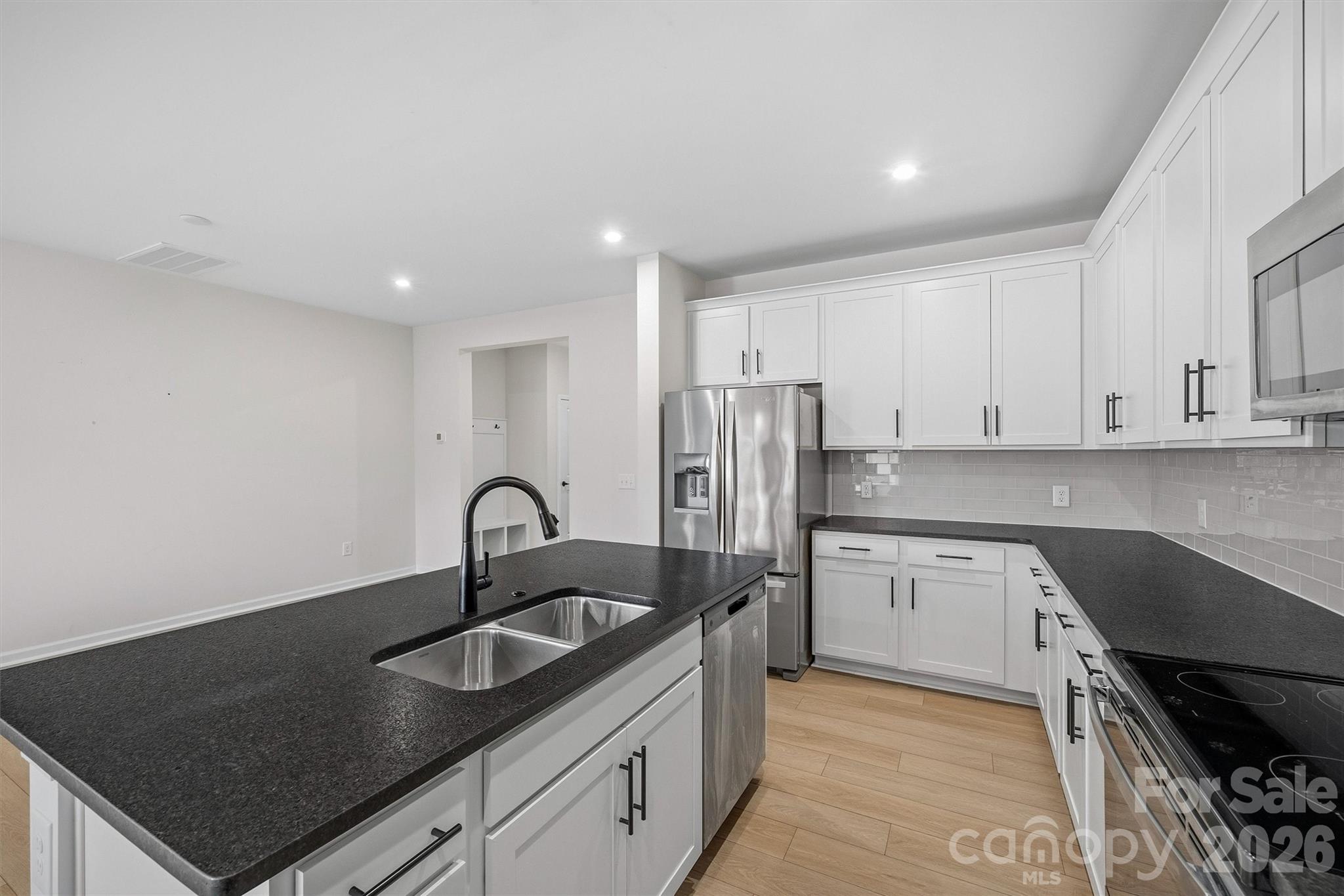 217 Brooks Springs Drive Fort Mill, SC 29708 - Photo 10 of 36 a kitchen with granite countertop a sink a stove and refrigerator
