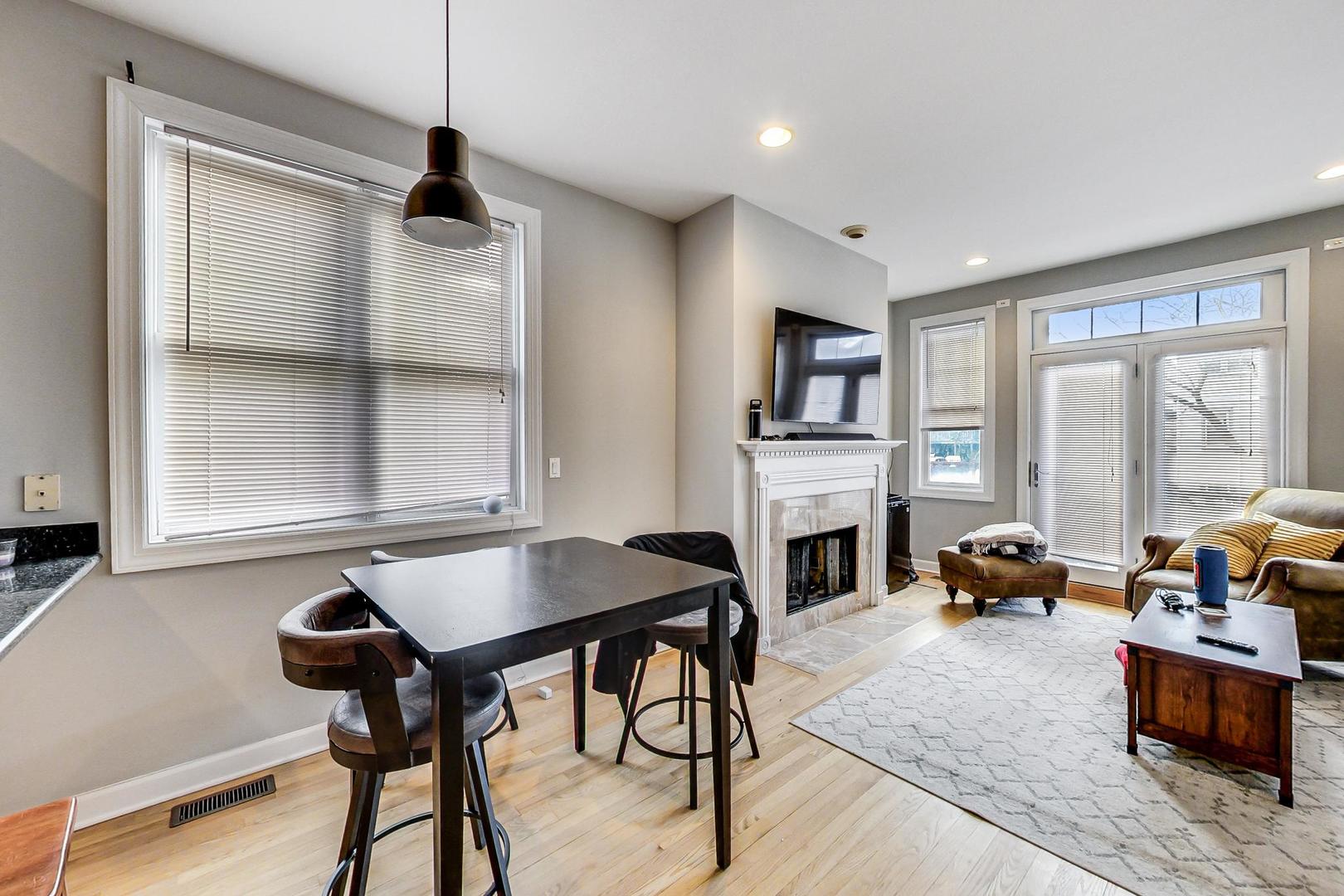 1330 West Fletcher Street, Unit 1 Chicago, IL 60657 - Photo 11 of 42 a livingroom with fireplace and dining area