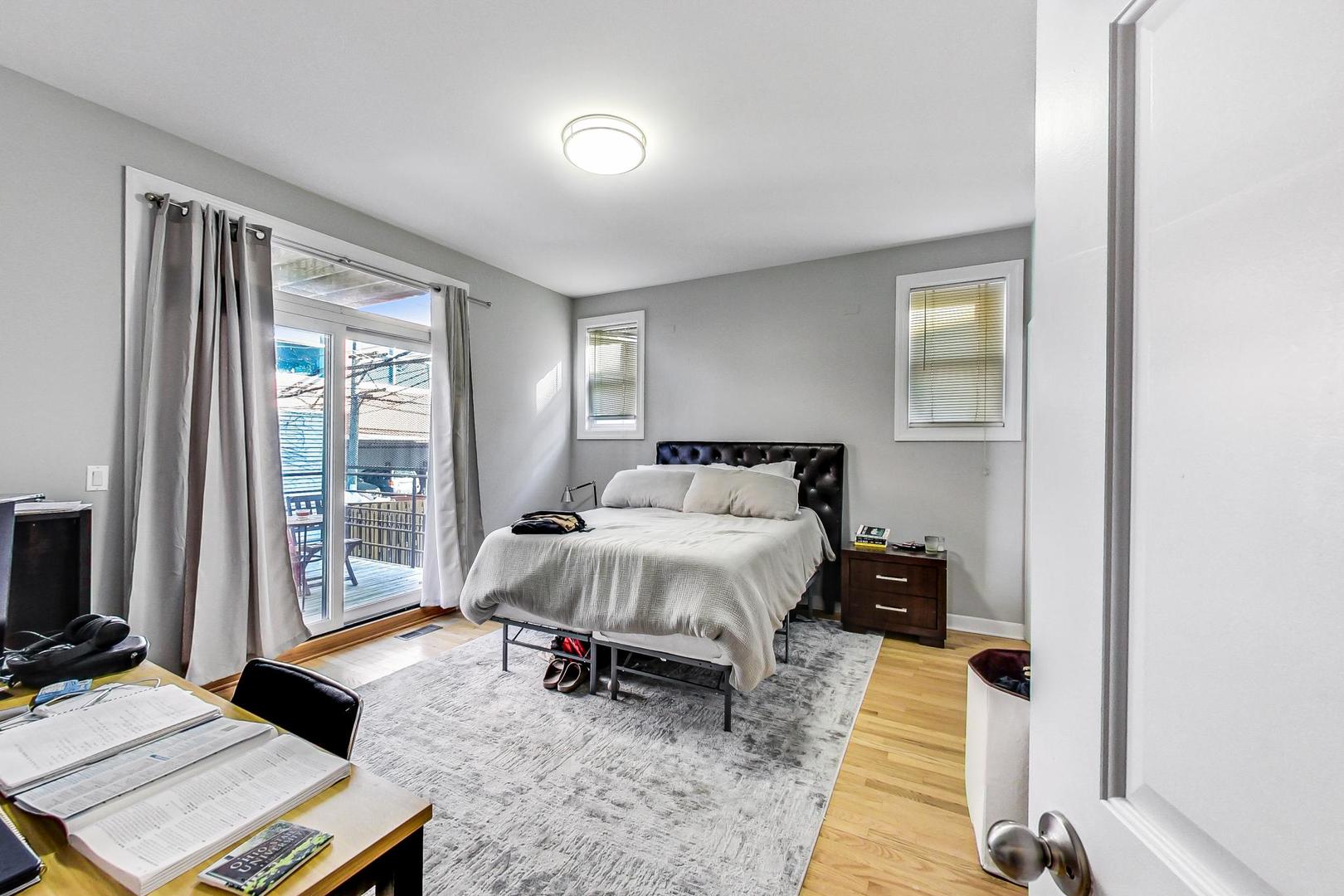 1330 West Fletcher Street, Unit 1 Chicago, IL 60657 - Photo 16 of 42 a bed room with a bed and a desk