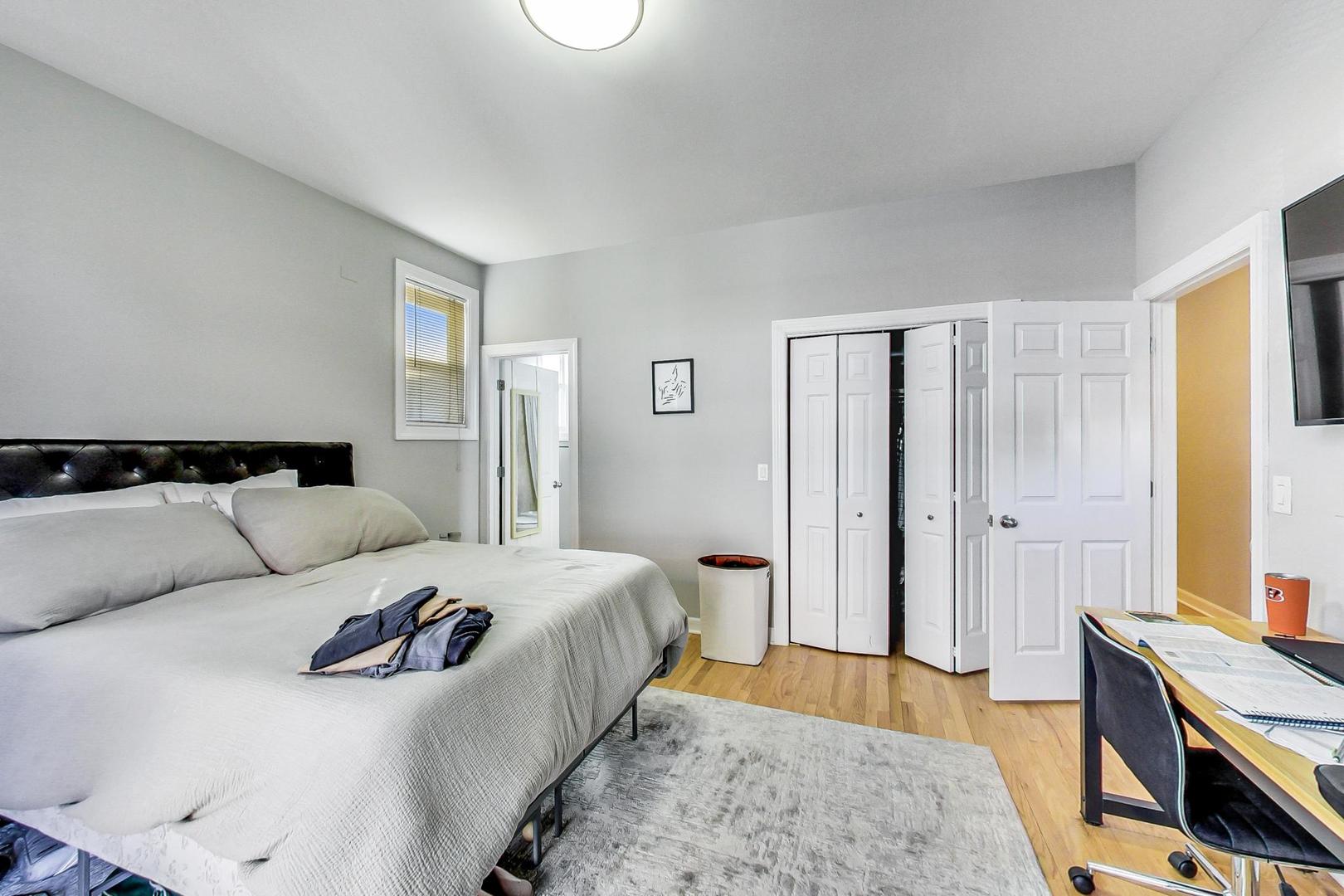 1330 West Fletcher Street, Unit 1 Chicago, IL 60657 - Photo 18 of 42 a bedroom with a bed and wooden floor