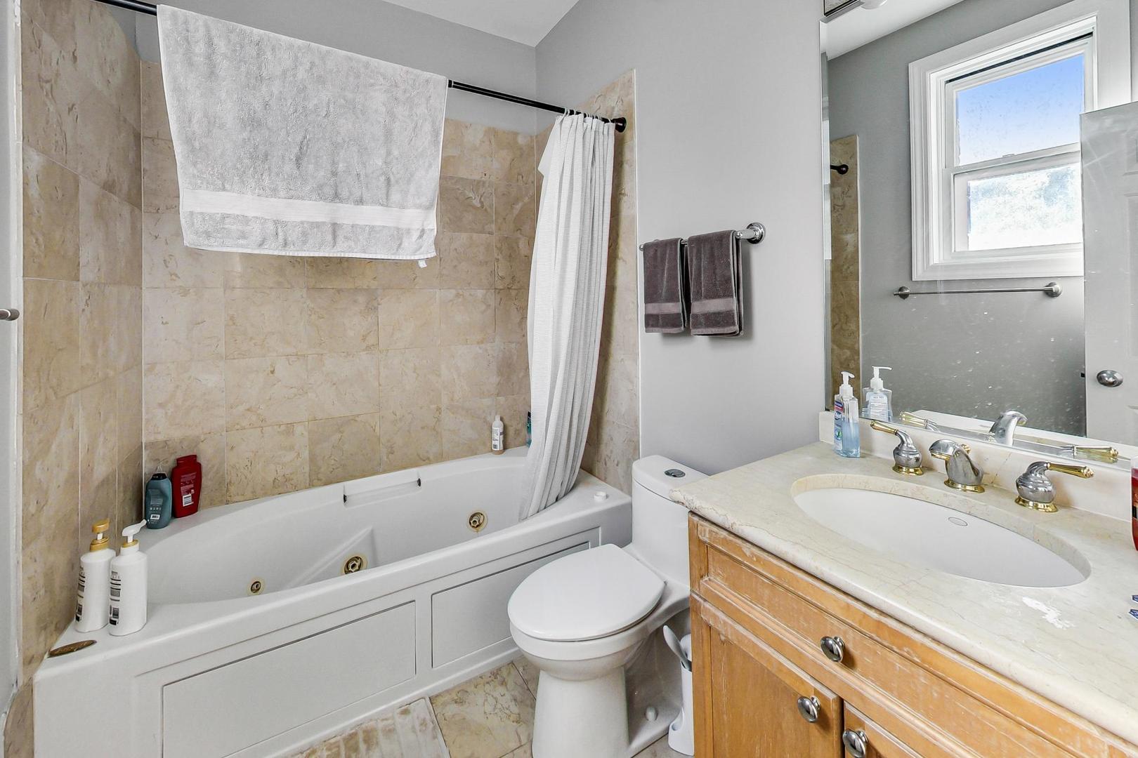 1330 West Fletcher Street, Unit 1 Chicago, IL 60657 - Photo 19 of 42 a bathroom with a sink toilet and shower