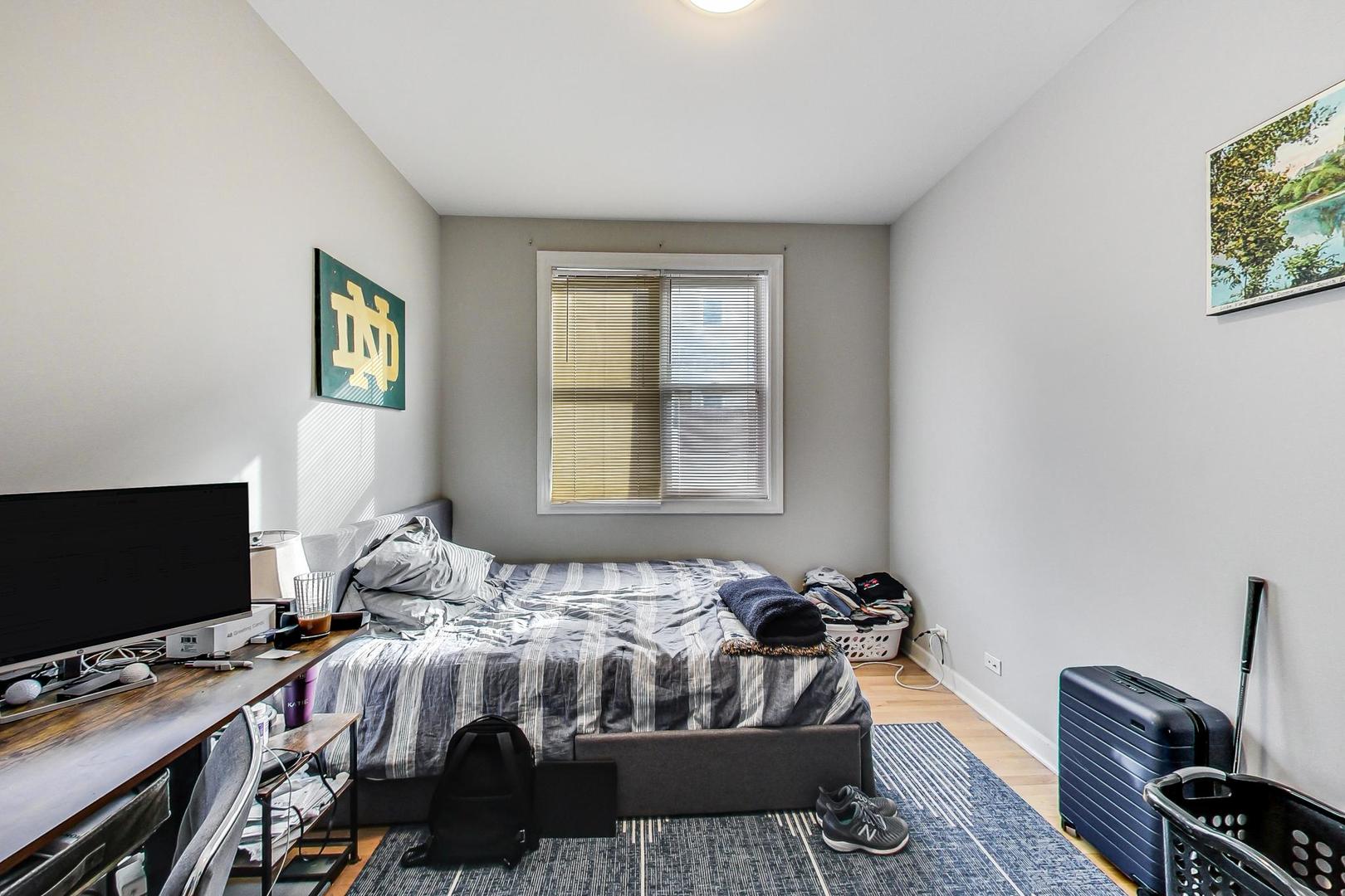 1330 West Fletcher Street, Unit 1 Chicago, IL 60657 - Photo 20 of 42 a bedroom with a bed and a flat screen tv