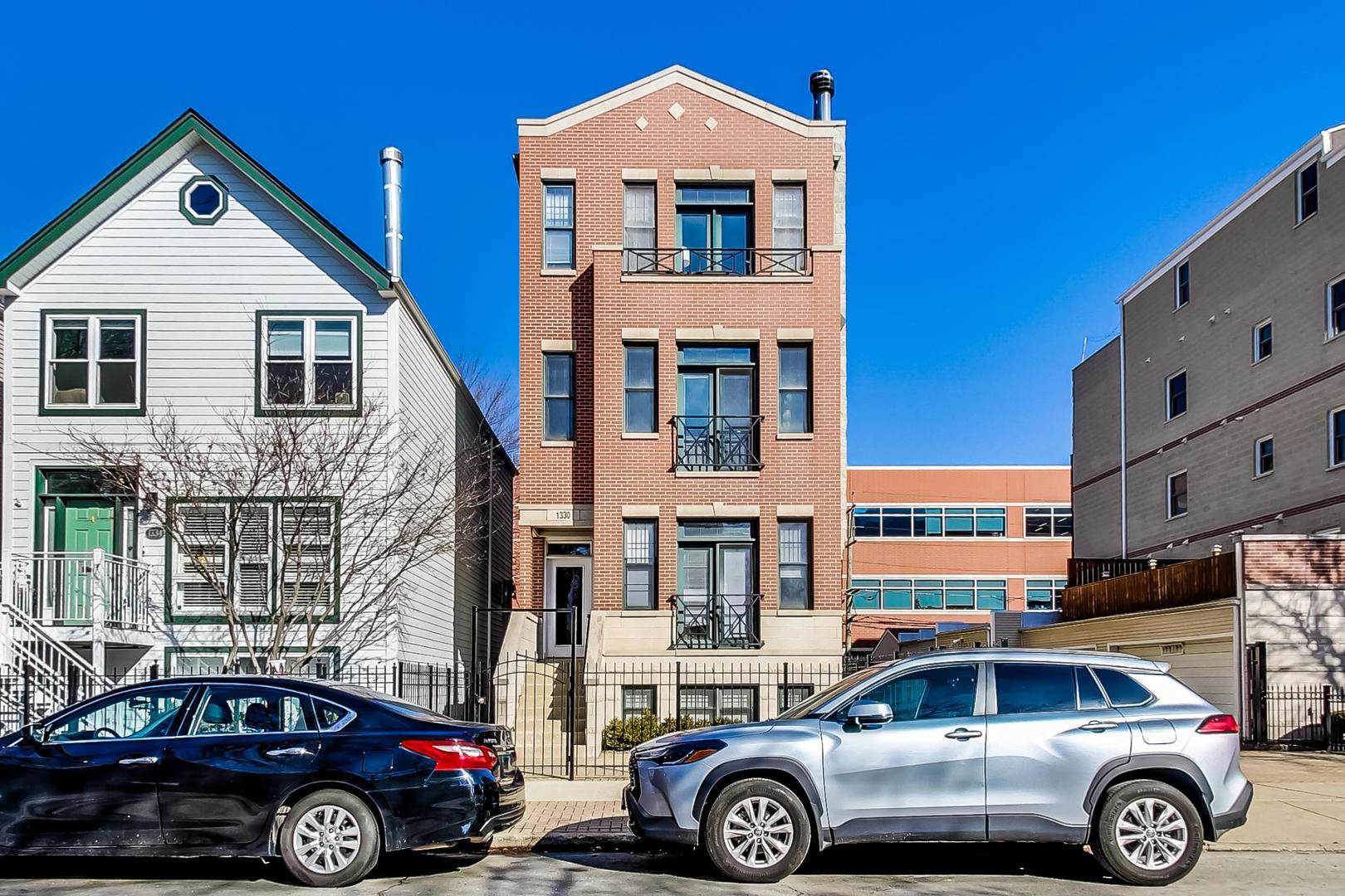 1330 West Fletcher Street, Unit 1 Chicago, IL 60657 - Photo 2 of 42 a front view of a house with parking space
