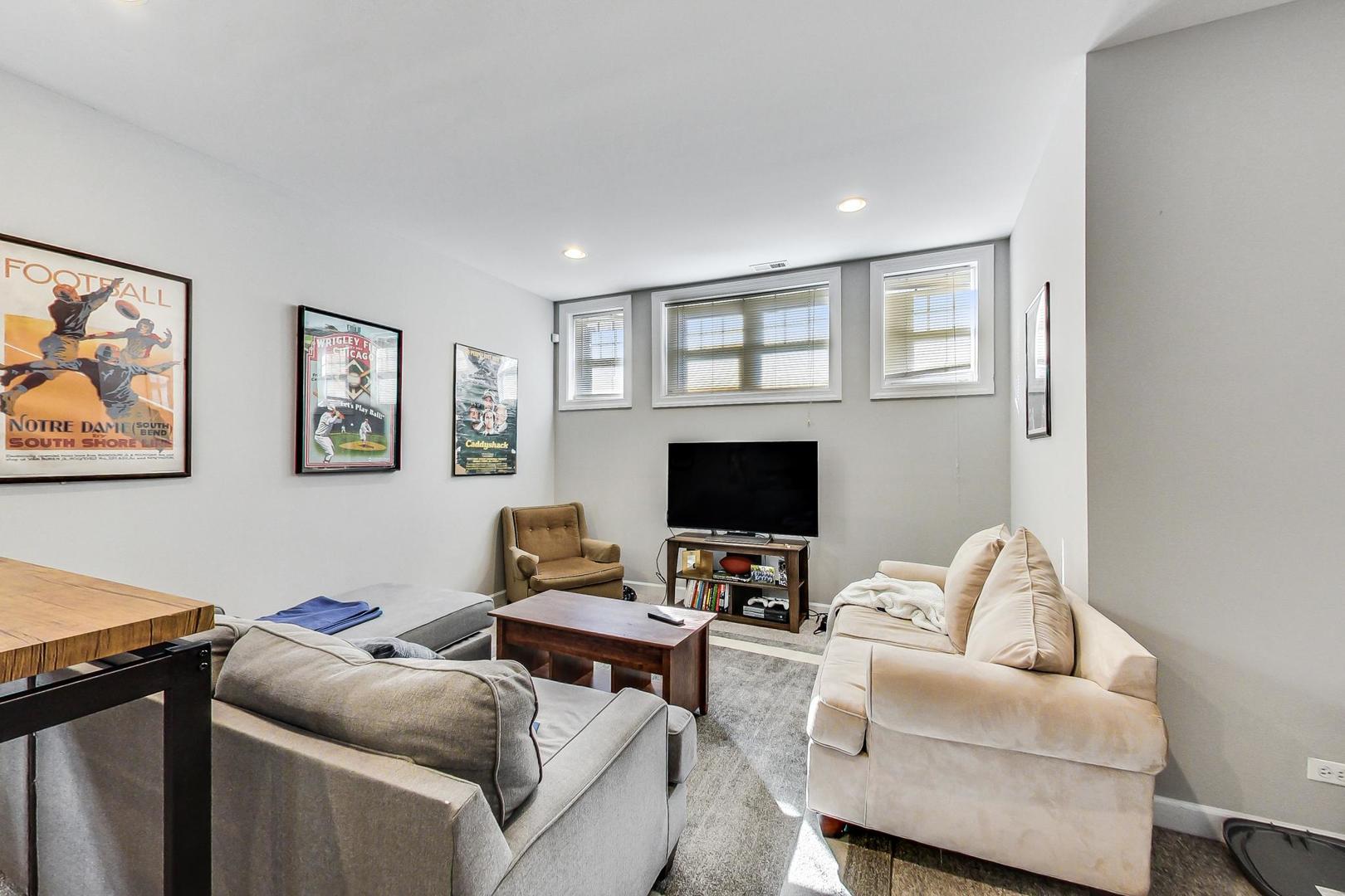 1330 West Fletcher Street, Unit 1 Chicago, IL 60657 - Photo 23 of 42 a living room with furniture and a flat screen tv