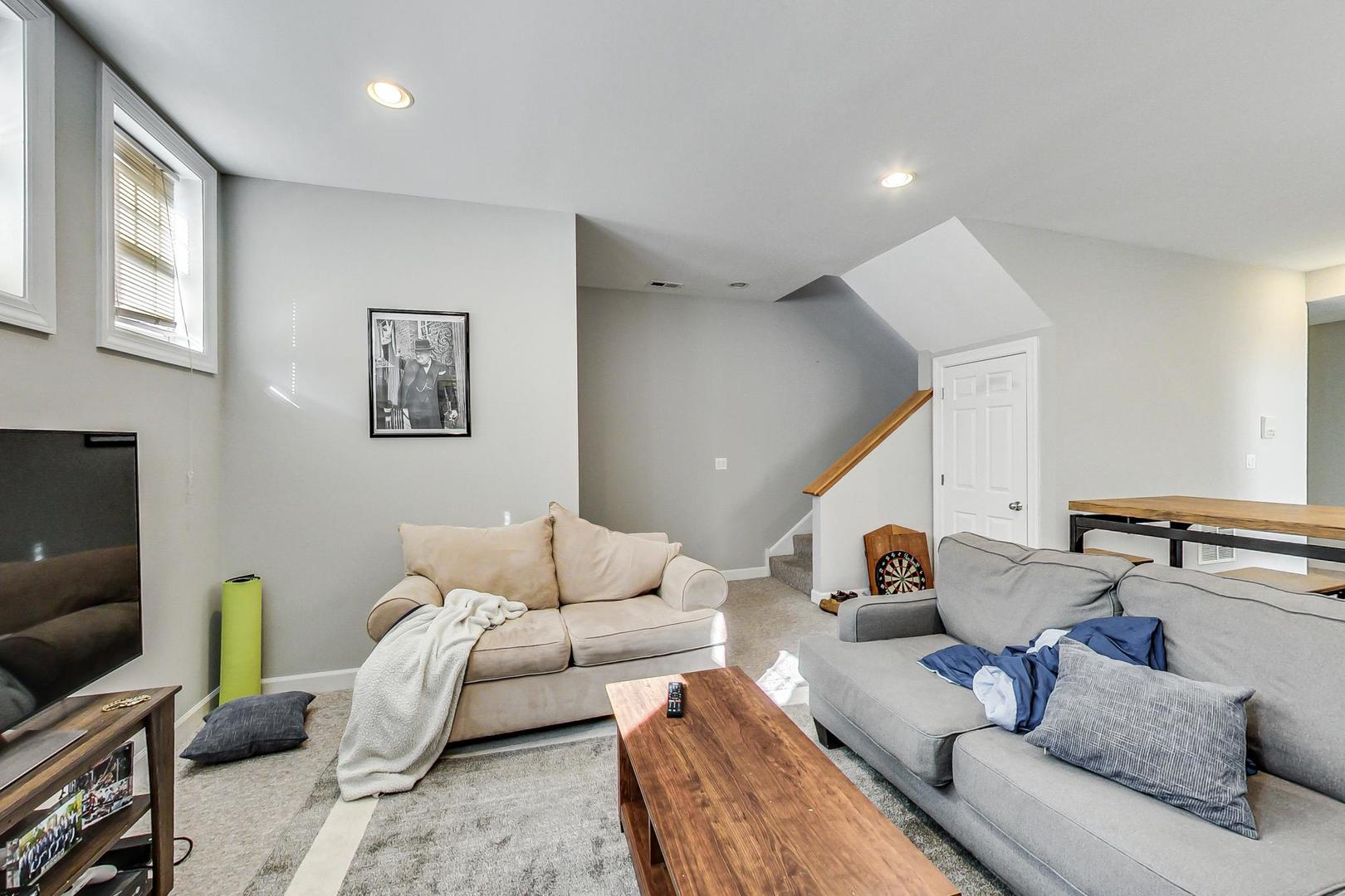 1330 West Fletcher Street, Unit 1 Chicago, IL 60657 - Photo 24 of 42 a living room with furniture and a flat screen tv