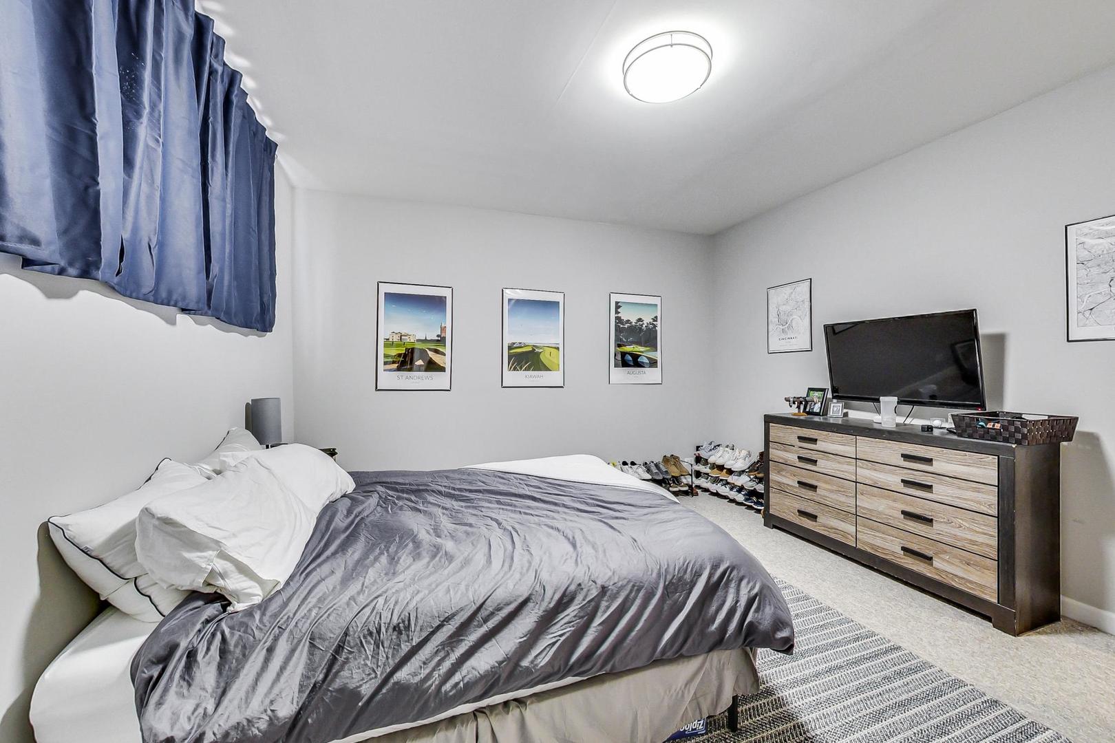 1330 West Fletcher Street, Unit 1 Chicago, IL 60657 - Photo 29 of 42 a bedroom with a bed and a flat screen tv