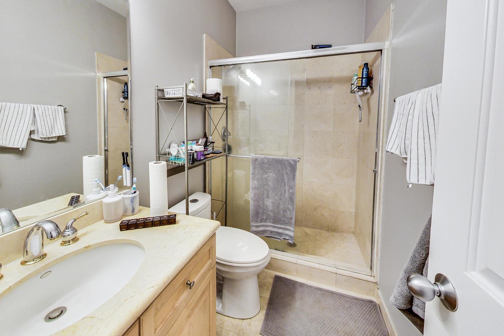 1330 West Fletcher Street, Unit 1 Chicago, IL 60657 - Photo 31 of 42 a bathroom with a sink toilet and shower