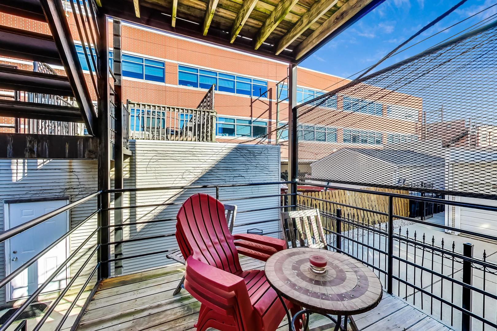 1330 West Fletcher Street, Unit 1 Chicago, IL 60657 - Photo 33 of 42 a balcony with table and chairs