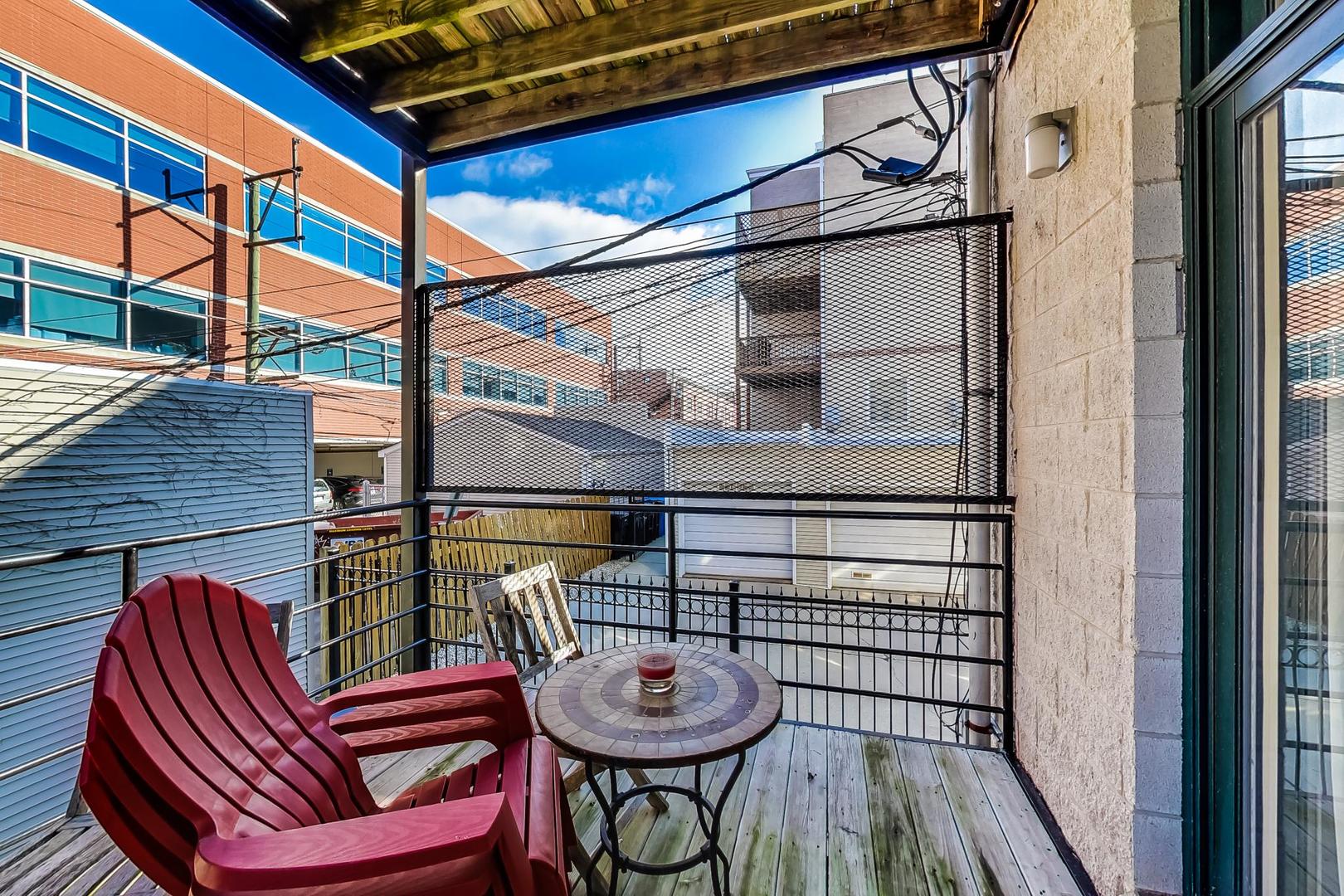 1330 West Fletcher Street, Unit 1 Chicago, IL 60657 - Photo 34 of 42 a view of a balcony with furniture and wooden floor