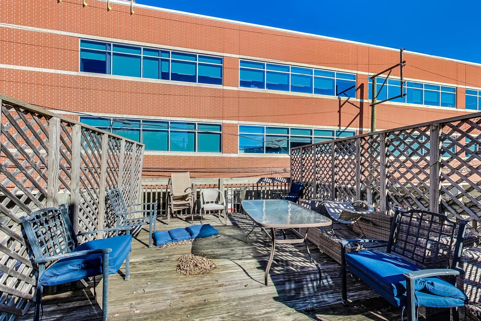 1330 West Fletcher Street, Unit 1 Chicago, IL 60657 - Photo 37 of 42 a roof deck view with table and chairs