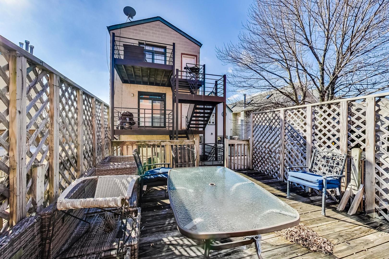 1330 West Fletcher Street, Unit 1 Chicago, IL 60657 - Photo 39 of 42 a view of a chairs and table in backyard