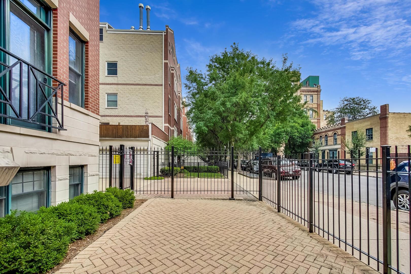 1330 West Fletcher Street, Unit 1 Chicago, IL 60657 - Photo 5 of 42 a view of a building with a bench in front of building