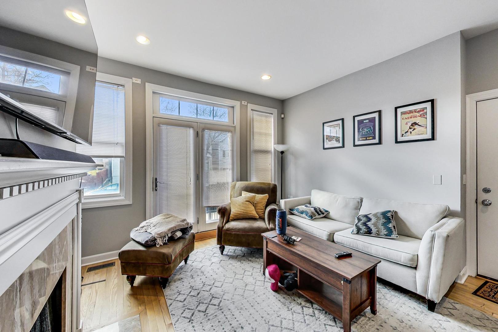 1330 West Fletcher Street, Unit 1 Chicago, IL 60657 - Photo 7 of 42 a living room with furniture and a fireplace