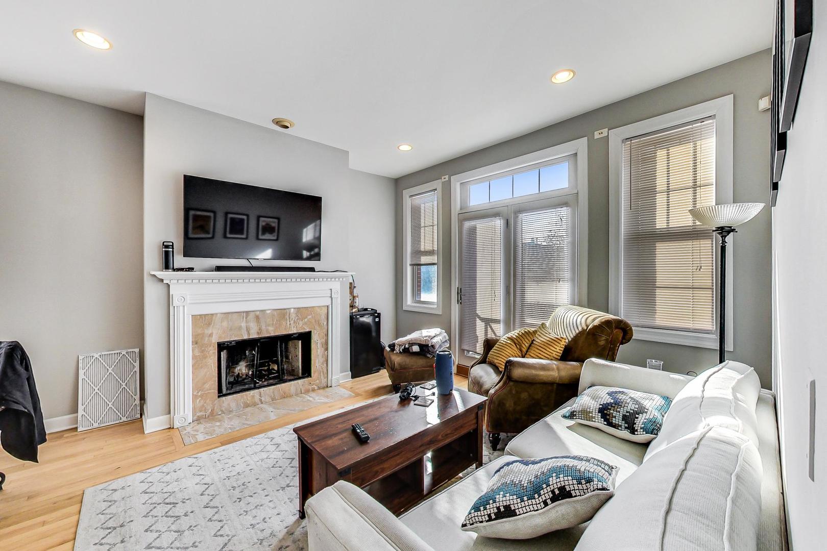 1330 West Fletcher Street, Unit 1 Chicago, IL 60657 - Photo 8 of 42 a living room with furniture fireplace and flat screen tv